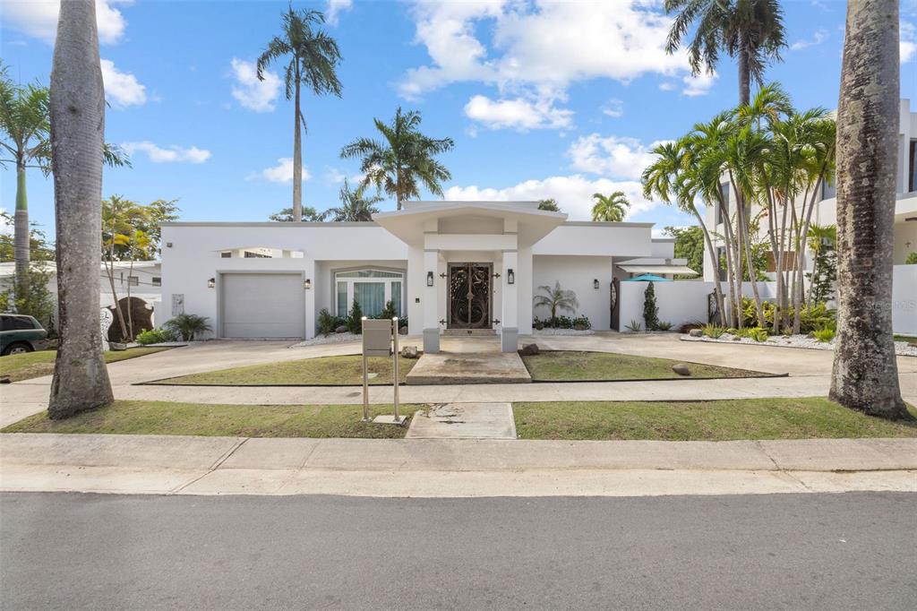 5 Union Guaynabo Prairie Guaynabo, PR 00966 - Photo 1 of 1 a front view of a house with a garden and patio