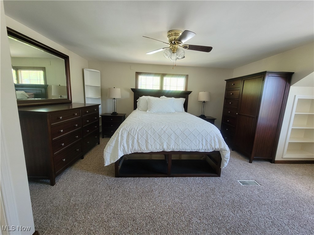 1372 Mayfield Ridge Road Cleveland, OH 44124 - Photo 20 of 37 Bedroom with multiple windows, light colored carpet, and ceiling fan