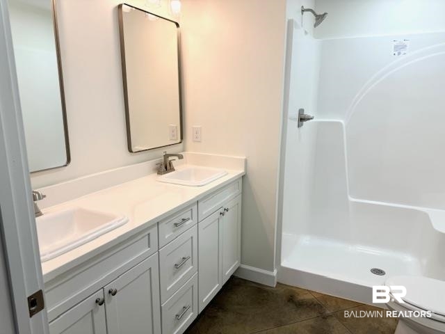 403 East 4th Street Bay Minette, AL 36507 - Photo 12 of 19 Bathroom with walk in shower, tile patterned floors, and double vanity