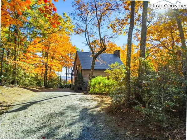 a view of a house with a tree in the background
