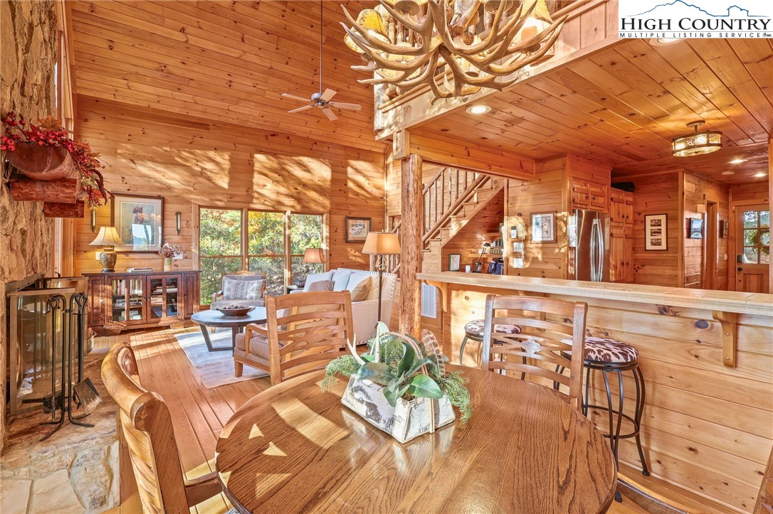 675 Cabin Ridge Road Ferguson, NC 28624 - Photo 11 of 50 a view of a patio with dining table and chairs with wooden floor