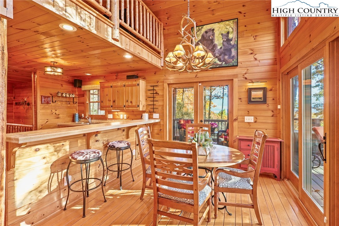 675 Cabin Ridge Road Ferguson, NC 28624 - Photo 13 of 50 a view of a dining room with furniture a chandelier and wooden floor