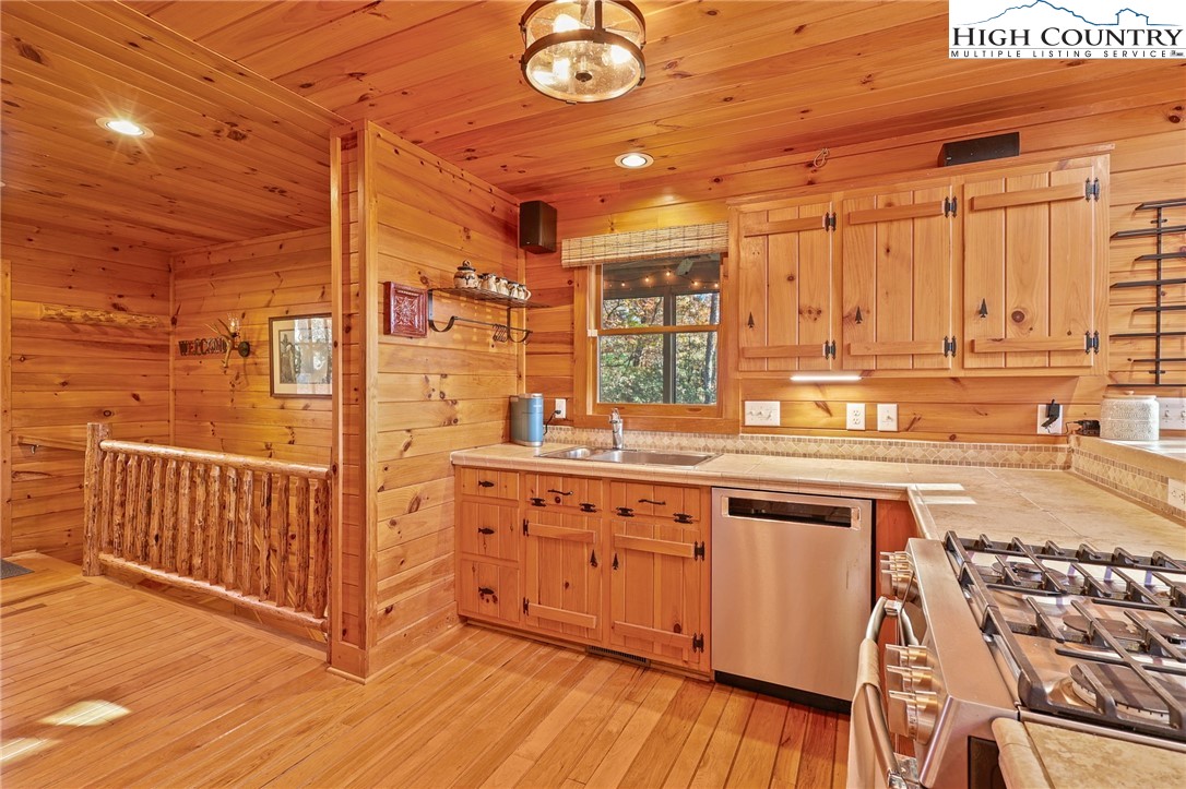 675 Cabin Ridge Road Ferguson, NC 28624 - Photo 19 of 50 a open kitchen with stainless steel appliances granite countertop a sink and cabinets