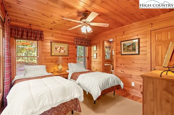 a bedroom with two beds and a large window