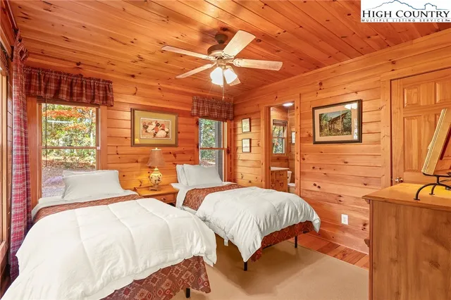 a bedroom with two beds and a large window