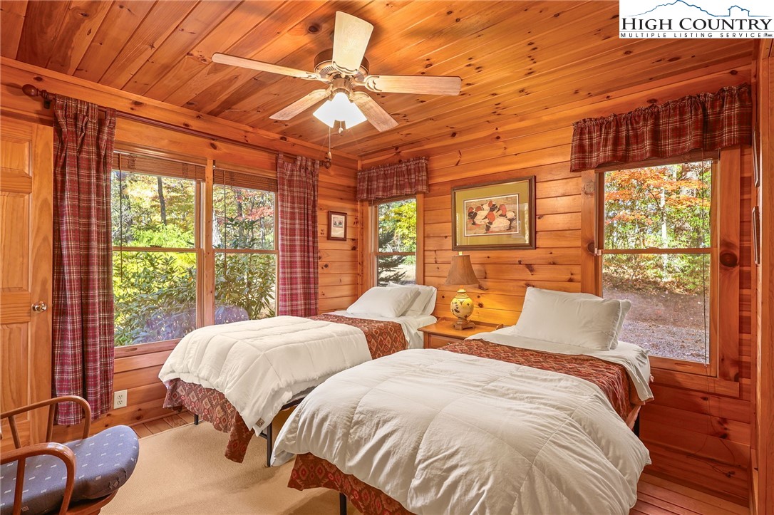 675 Cabin Ridge Road Ferguson, NC 28624 - Photo 22 of 50 a bedroom with two beds and a large window