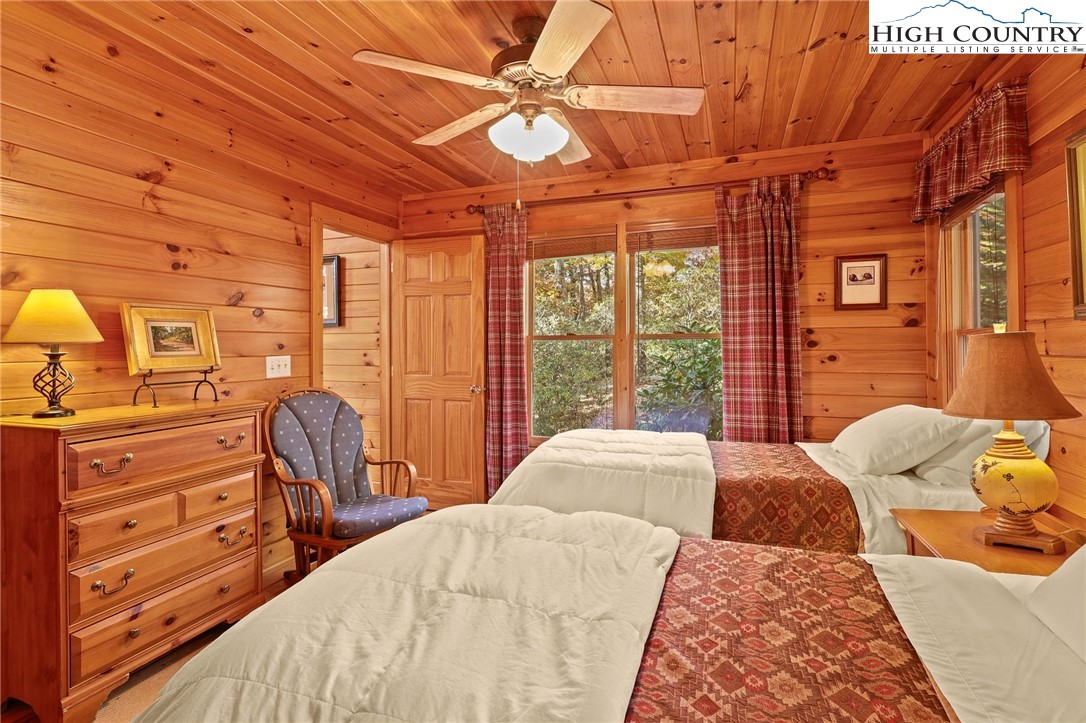 675 Cabin Ridge Road Ferguson, NC 28624 - Photo 23 of 50 a bedroom with a bed and wooden floor