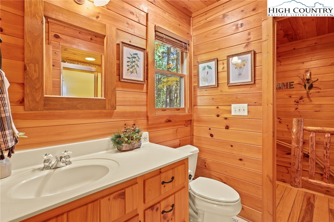 675 Cabin Ridge Road Ferguson, NC 28624 - Photo 24 of 50 a bathroom with a granite countertop sink toilet mirror and shower