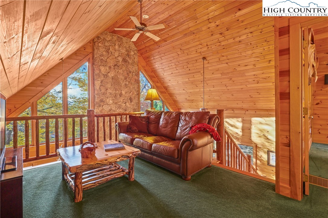 675 Cabin Ridge Road Ferguson, NC 28624 - Photo 28 of 50 a roof deck with a couch and wooden fence