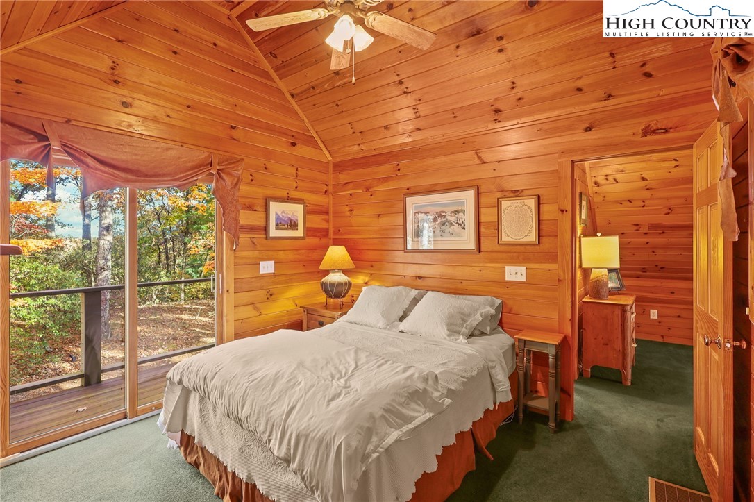 675 Cabin Ridge Road Ferguson, NC 28624 - Photo 30 of 50 a bedroom with a bed and wooden floor