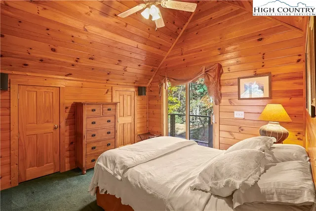 a large bed sitting in a bedroom next to a window