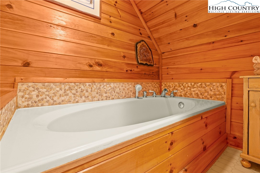 675 Cabin Ridge Road Ferguson, NC 28624 - Photo 34 of 50 a bathroom with a bathtub and shower