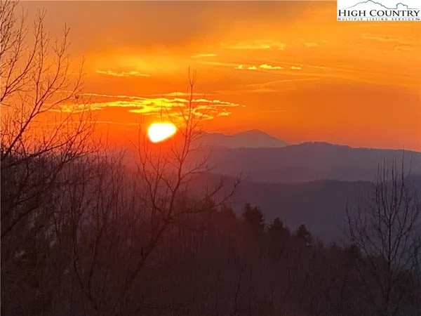 a view of brick house with a yard