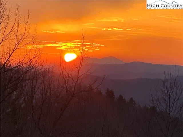 a view of brick house with a yard