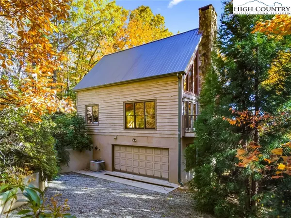 a view of a house with a tree in the background