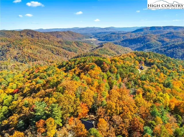 a view of a house with a tree in the background