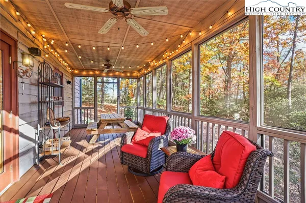 a living room with fireplace furniture and a large window