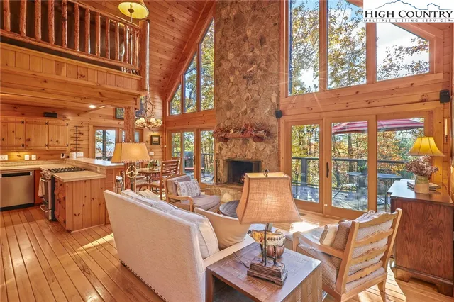 a living room with furniture and a floor to ceiling window