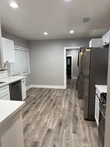 a kitchen with stainless steel appliances a refrigerator and a sink
