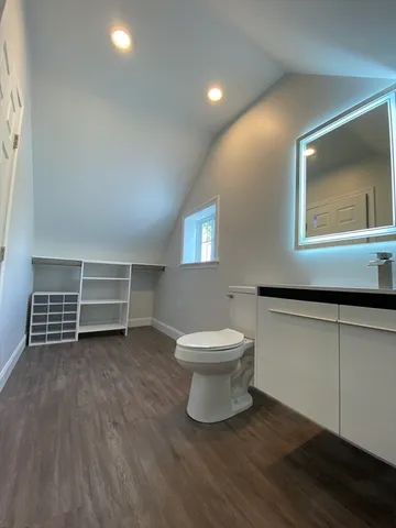 a view of a room with wooden floor and window
