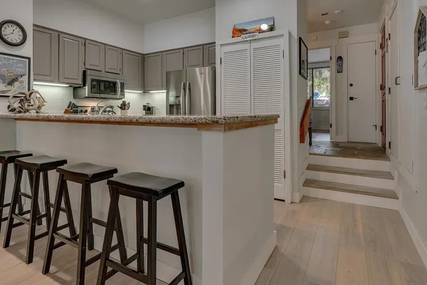 a kitchen with stainless steel appliances a refrigerator and microwave
