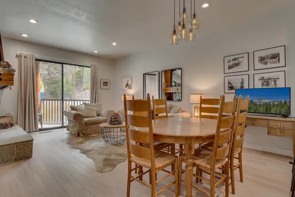 a view of a dining room with furniture large windows and wooden floor