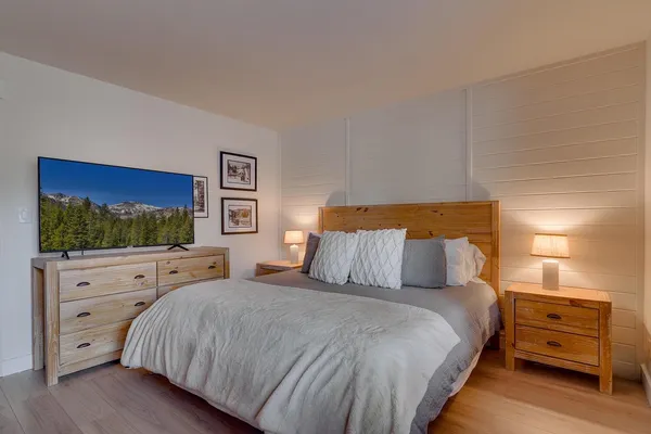 a bedroom with a bed and a flat screen tv