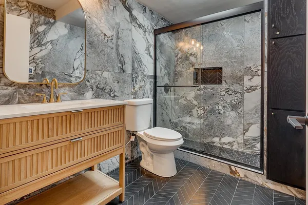 a bathroom with a toilet and a shower