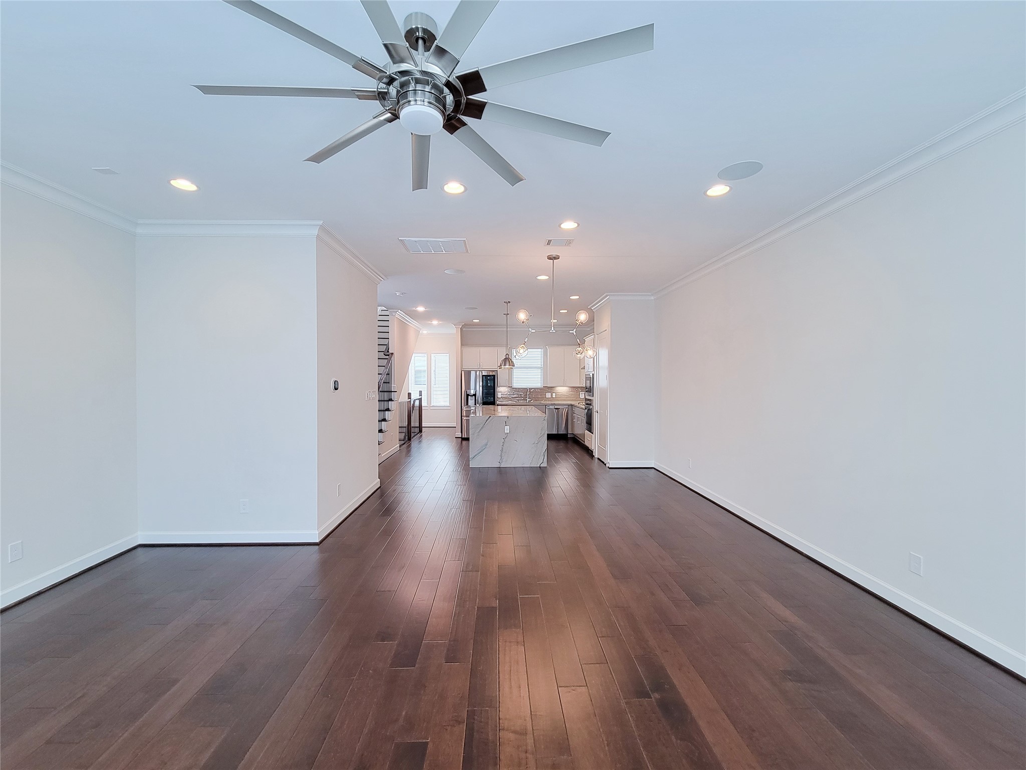 845 Fisher Street, Unit E Houston, TX 77018 - Photo 25 of 47 a view of a big room with wooden floor a ceiling fan and windows