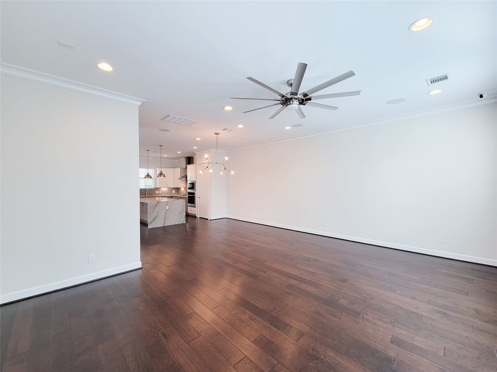 845 Fisher Street, Unit E Houston, TX 77018 - Photo 26 of 47 an empty room with wooden floor and a ceiling fan
