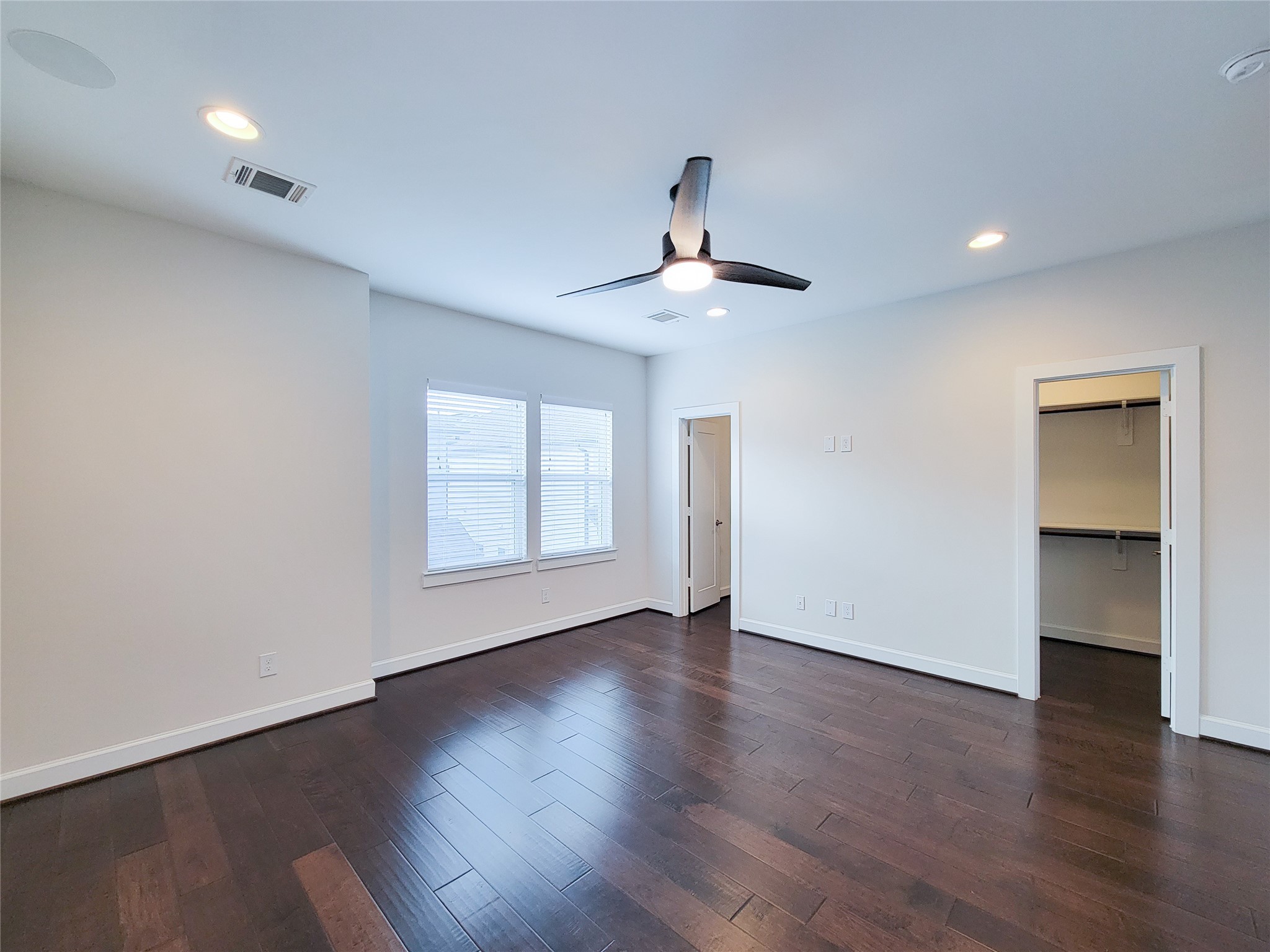 845 Fisher Street, Unit E Houston, TX 77018 - Photo 38 of 47 a view of an empty room with wooden floor and a window