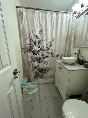 a bathroom with a sink vanity granite and a mirror
