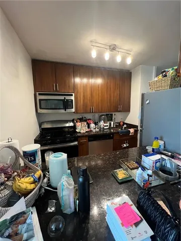 a kitchen with sink refrigerator and stove