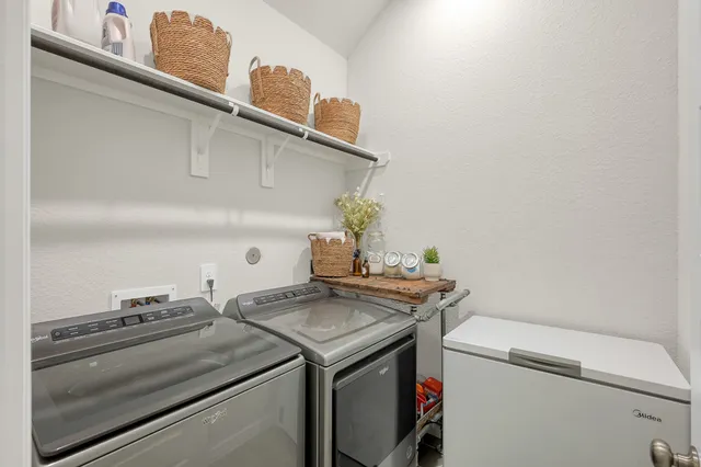 a view of a hallway with wooden floor and a potted plant