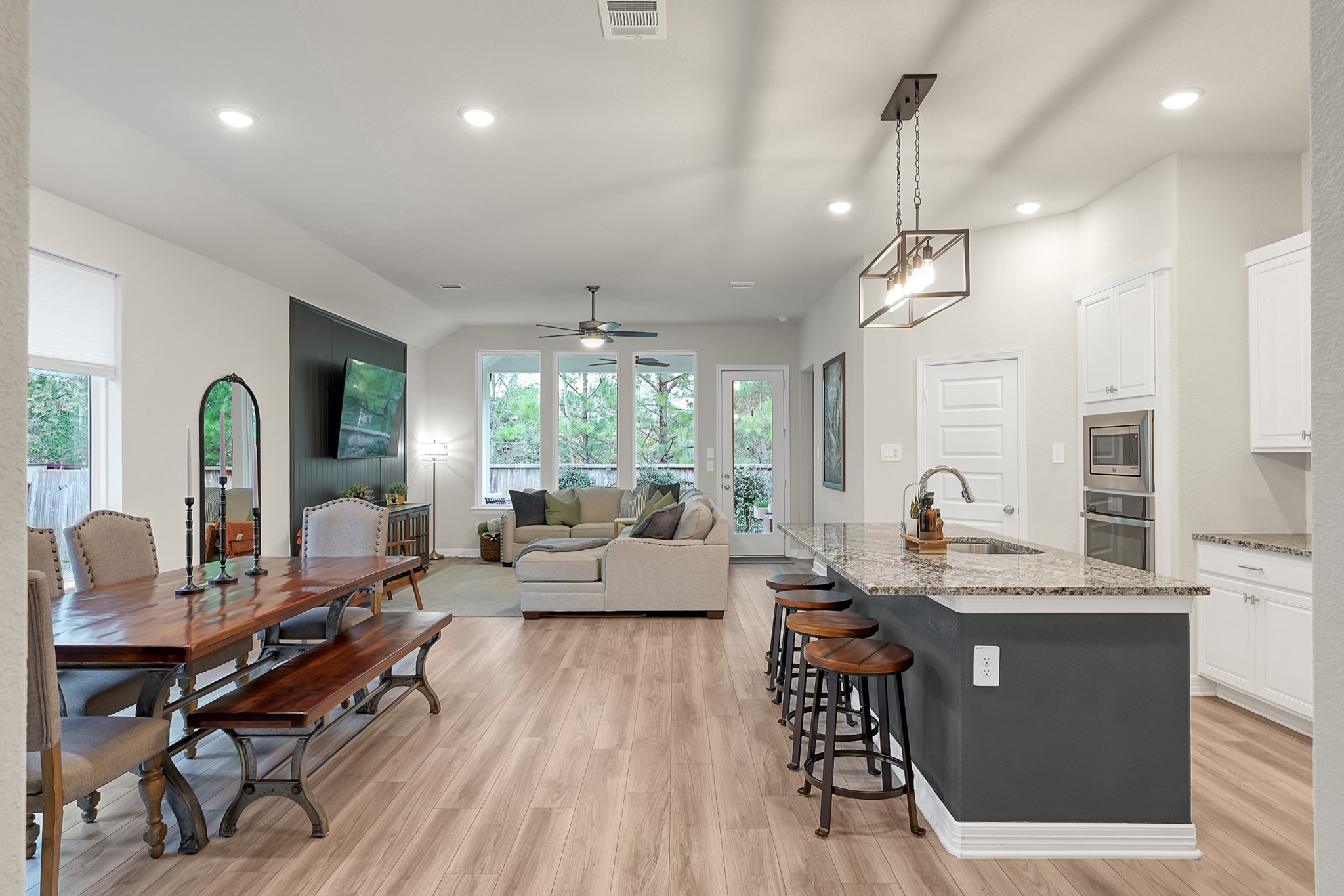 105 Dove Springs Court Conroe, TX 77304 - Photo 13 of 49 a living room with lots of furniture wooden floor and a chandelier