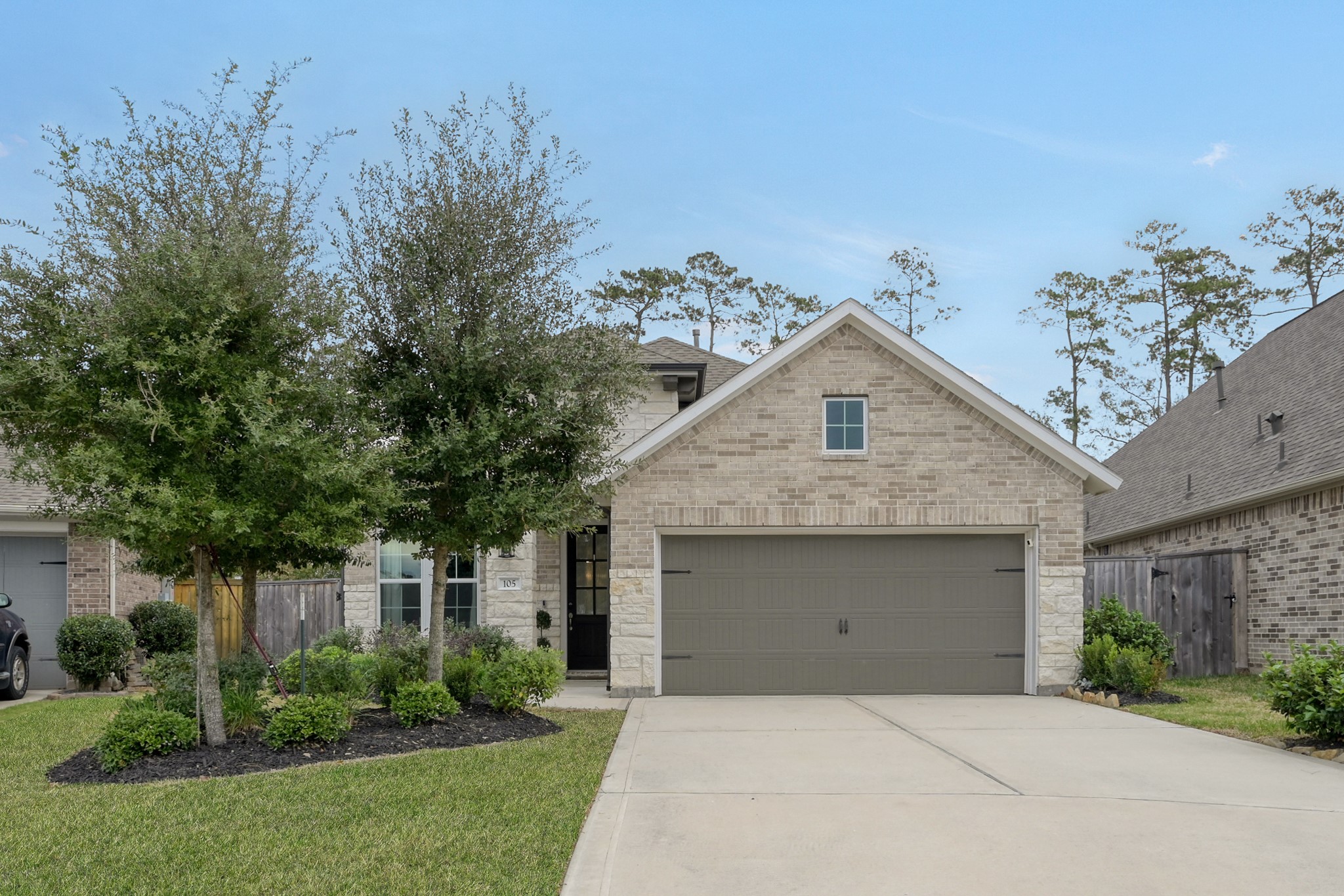105 Dove Springs Court Conroe, TX 77304 - Photo 2 of 49 a front view of a house with yard and green space