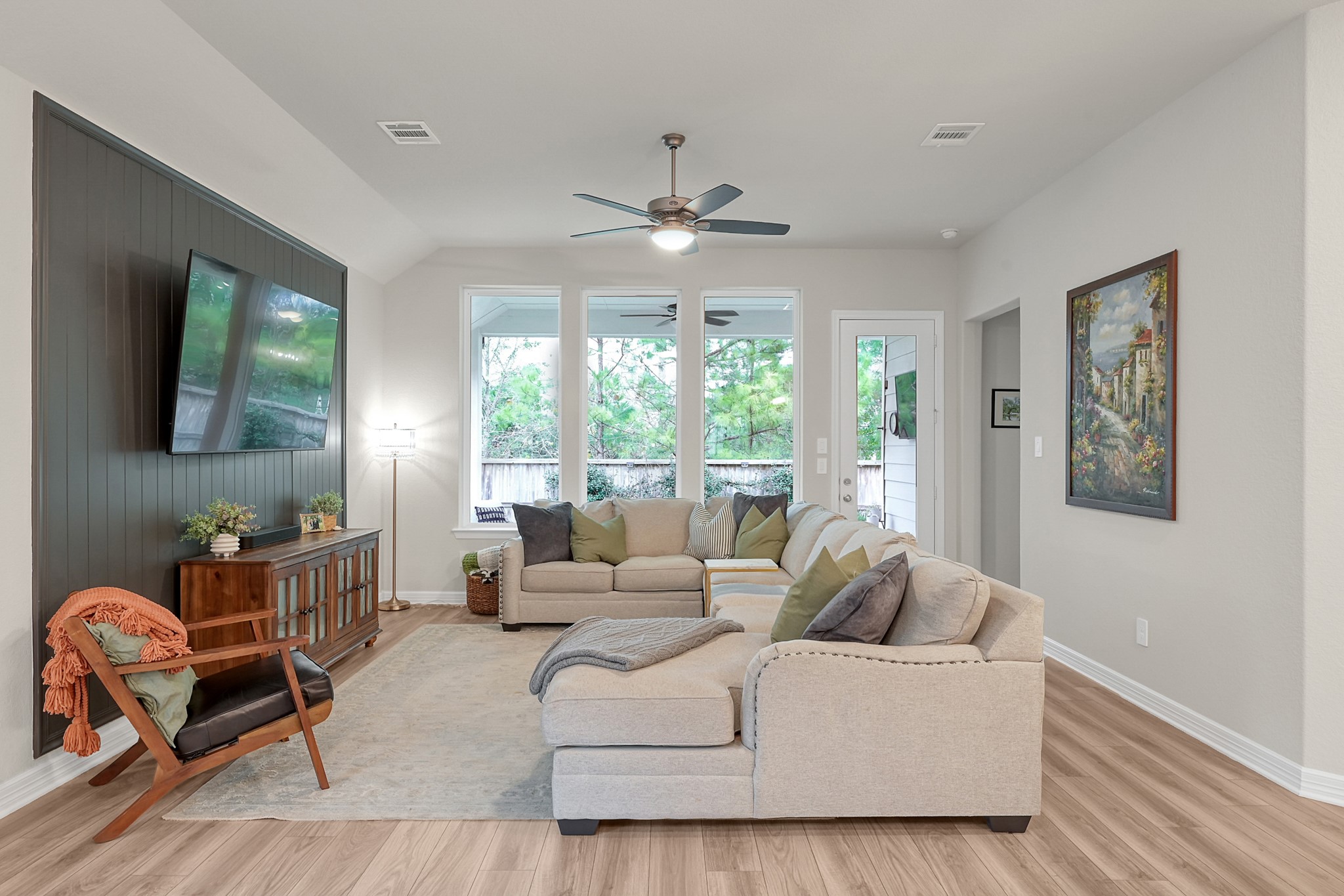105 Dove Springs Court Conroe, TX 77304 - Photo 24 of 49 a living room with furniture a flat screen tv and a large window