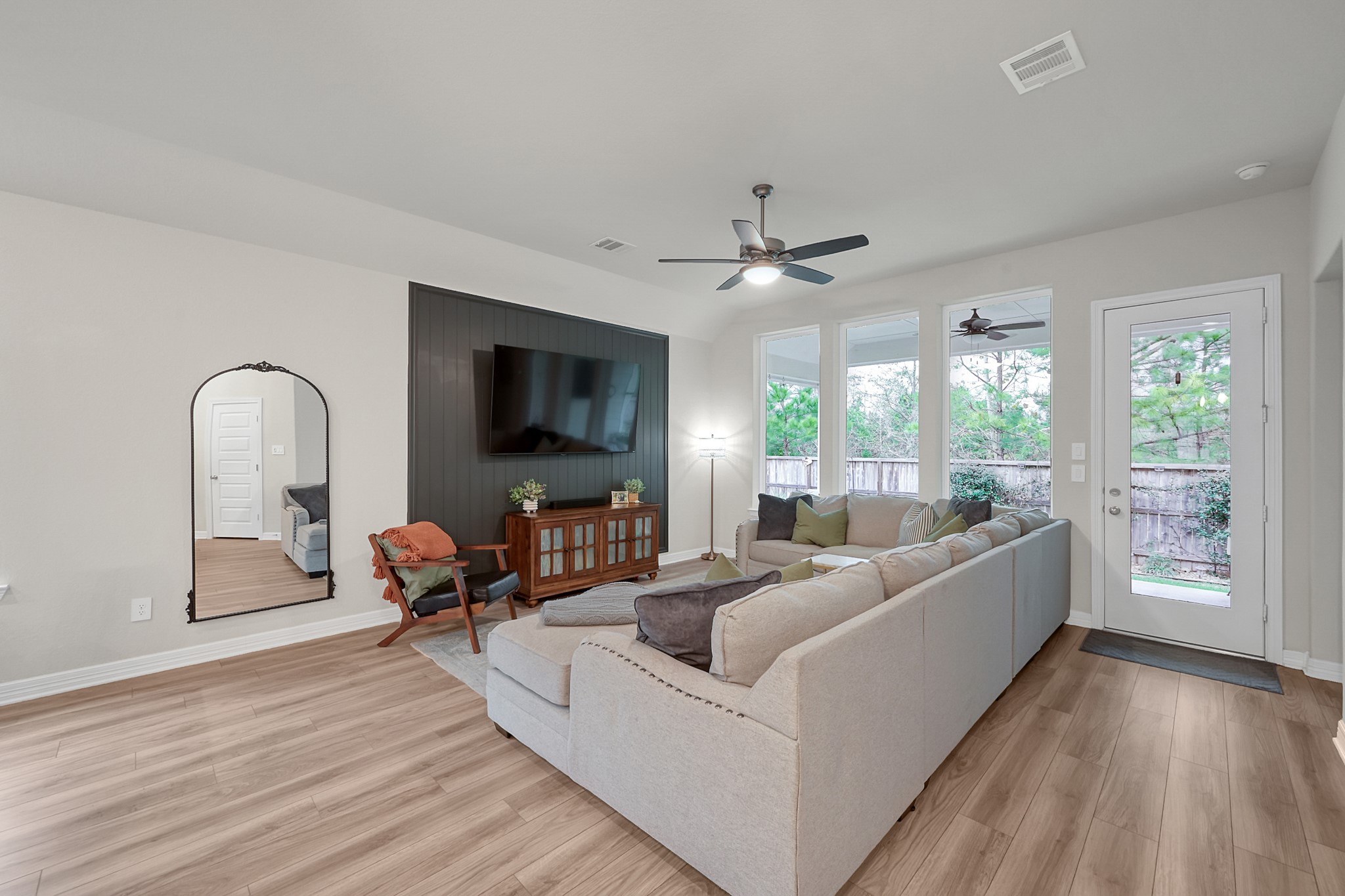105 Dove Springs Court Conroe, TX 77304 - Photo 25 of 49 a living room with furniture and a flat screen tv