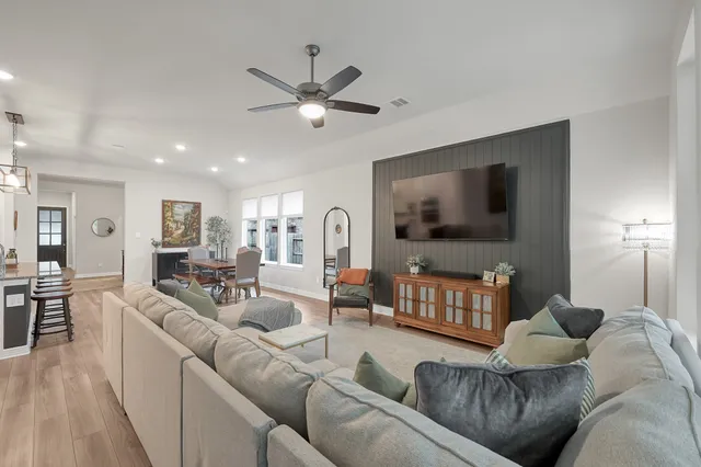 a living room with furniture and a flat screen tv