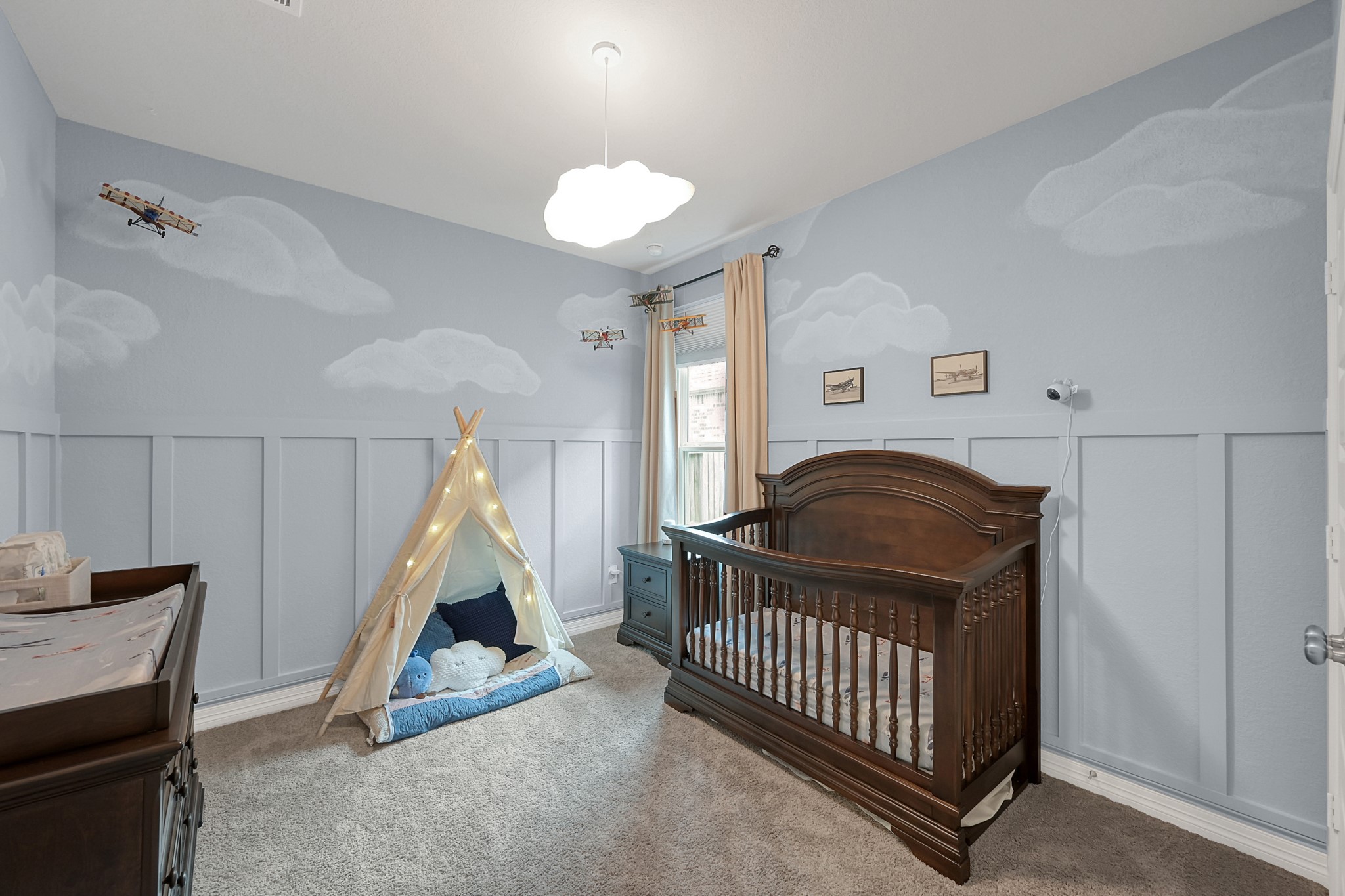 105 Dove Springs Court Conroe, TX 77304 - Photo 31 of 49 a living room with a baby crib furniture and a wooden floor