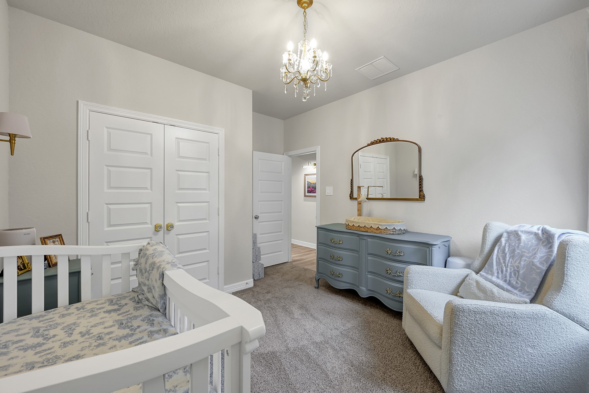 105 Dove Springs Court Conroe, TX 77304 - Photo 37 of 49 a living room with furniture and a chandelier