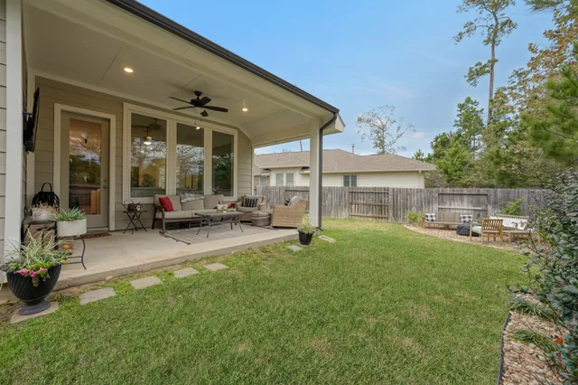 a view of a house with backyard sitting area and garden