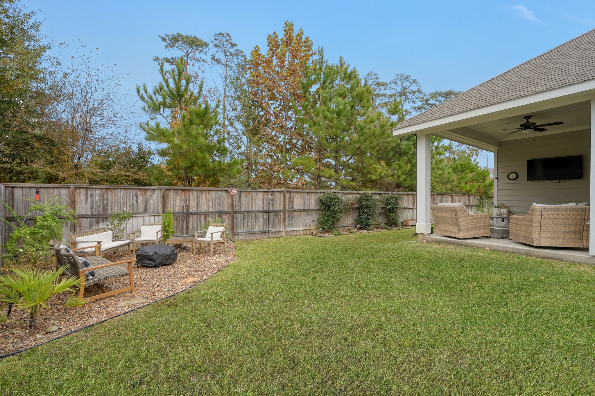105 Dove Springs Court Conroe, TX 77304 - Photo 42 of 49 a view of a patio with couches chairs and a table and chairs with wooden fence