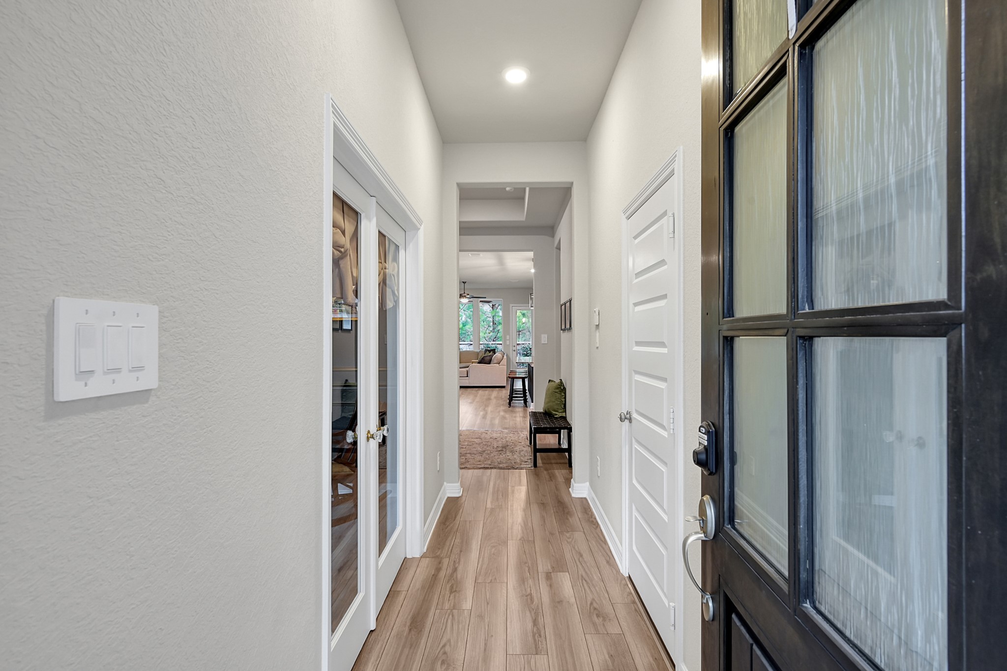 105 Dove Springs Court Conroe, TX 77304 - Photo 5 of 49 a view of a hallway with wooden floor and staircase