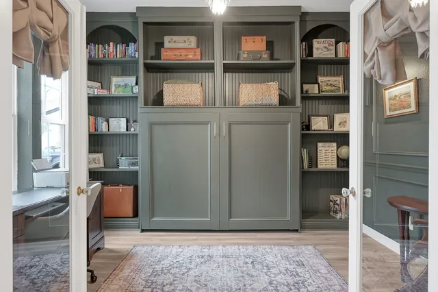 a view of a hallway with wooden floor and staircase