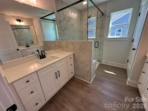 a spacious bathroom with a double vanity sink and mirror