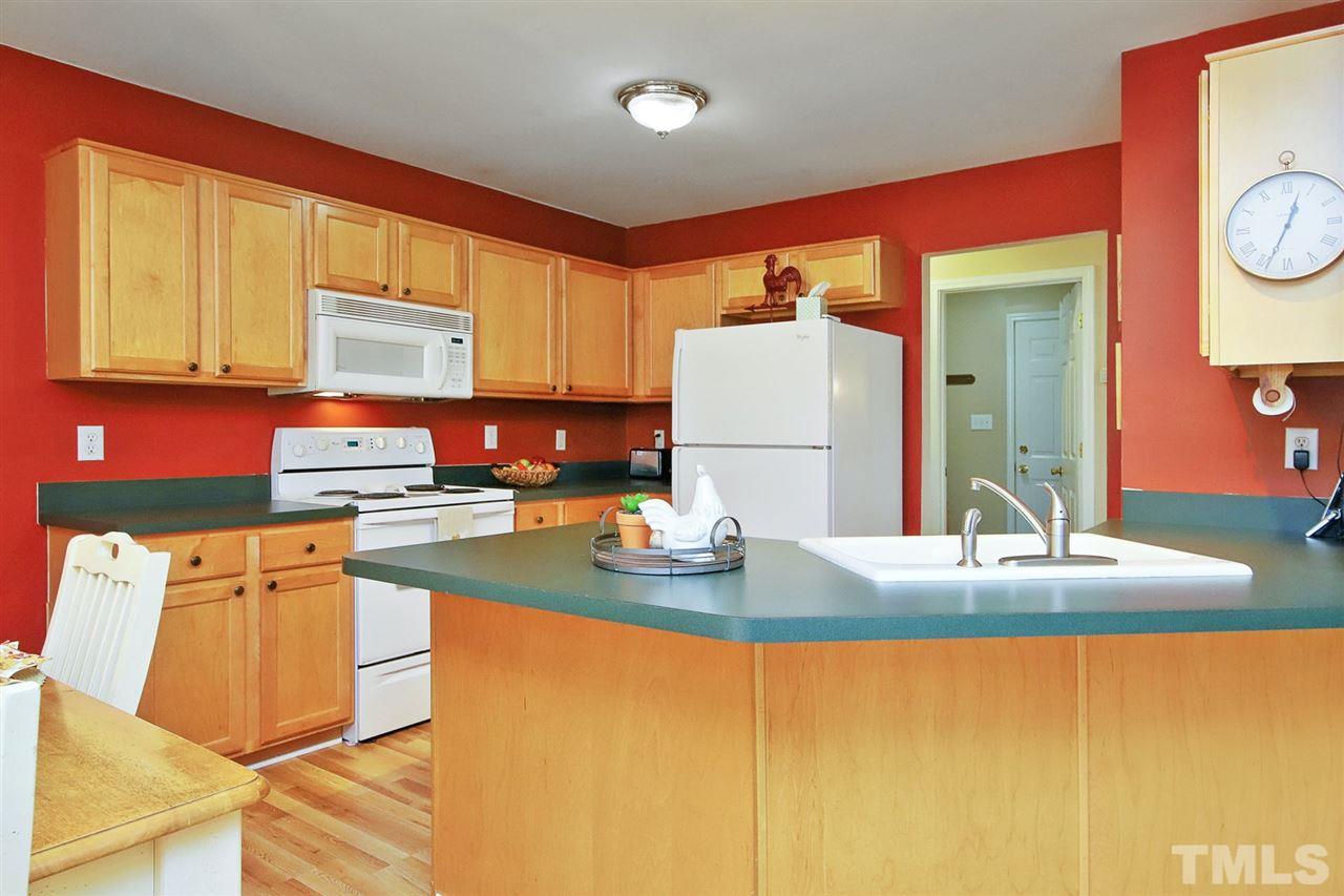 200 Melksham Road Wake Forest, NC 27587 - Photo 10 of 29 a kitchen with stainless steel appliances granite countertop a sink and a refrigerator