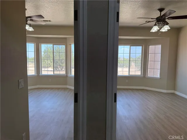 a view of a room with wooden floor