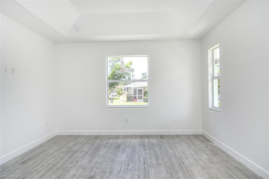 18412 Fuchsia Road Fort Myers, FL 33967 - Photo 12 of 23 an empty room with wooden floor and windows