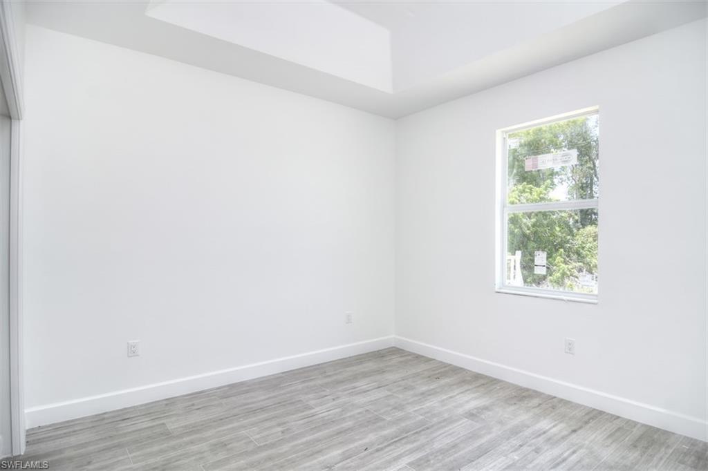 18412 Fuchsia Road Fort Myers, FL 33967 - Photo 13 of 23 an empty room with wooden floor and windows
